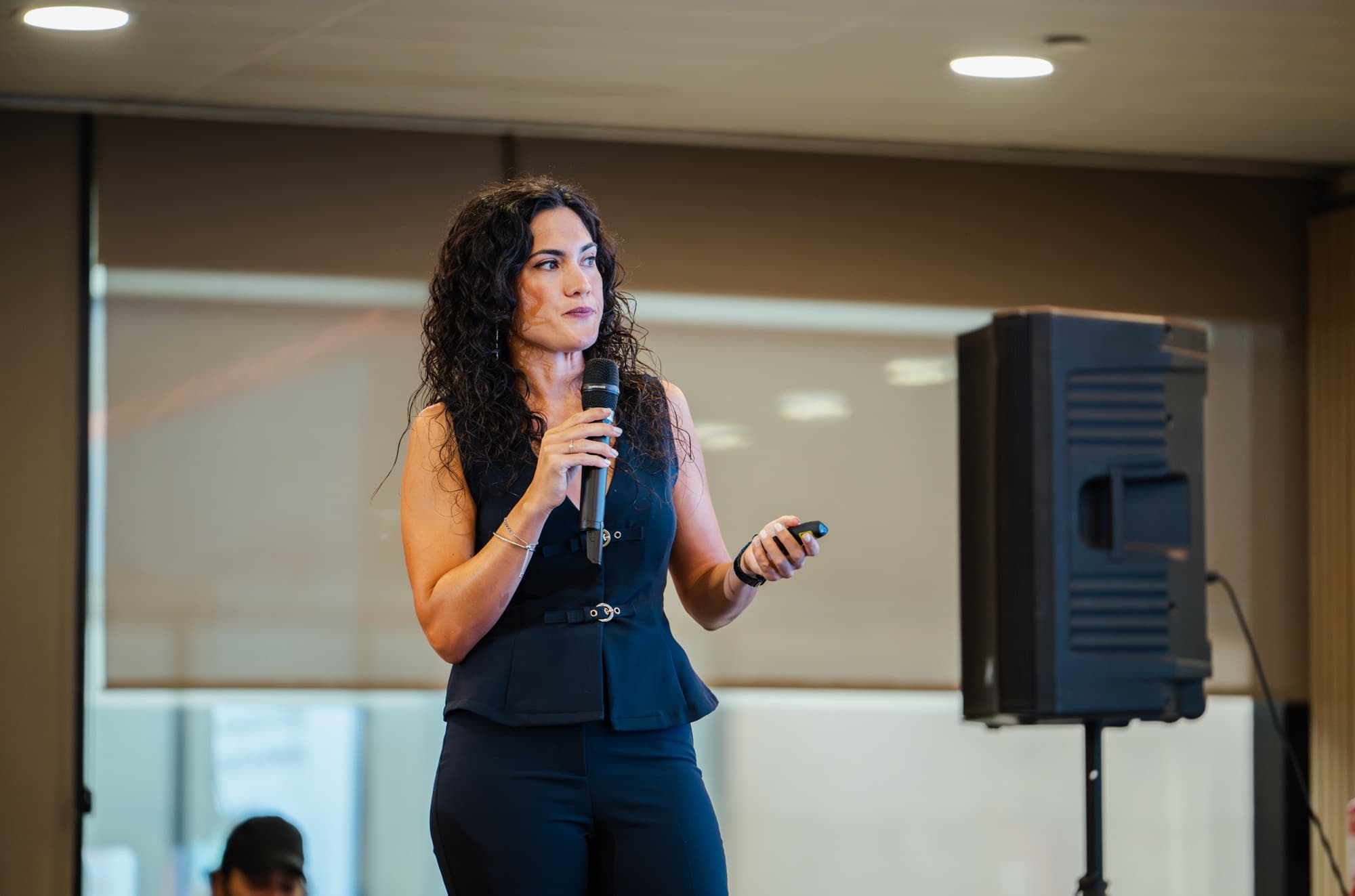 Olga Paredes hablando con micrófono durante una sesión presencial
